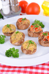 Stuffed mushrooms on plate on table close-up