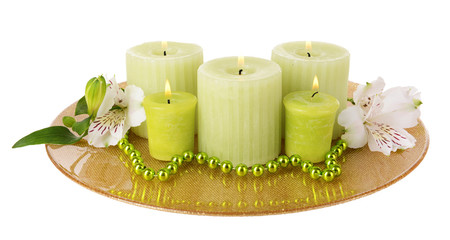 Beautiful candles with flowers isolated on white