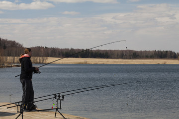 fisherman checks fishing rod