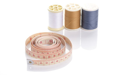measuring tape and rolls of thread