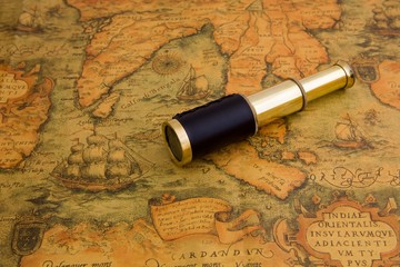 Vintage telescope on a antique map