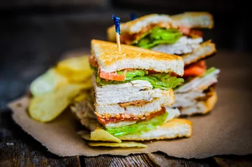 Tuinposter Club sandwich on rustic wooden background © ehaurylik