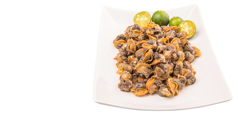 Fresh boiled cockle meat with calamansi fruit in a white plate