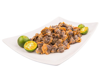 Fresh boiled cockle meat with calamansi fruit in a white plate