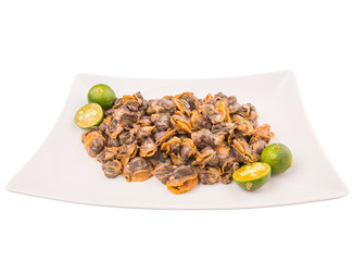 Fresh boiled cockle meat with calamansi fruit in a white plate