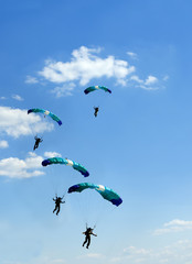 Naklejka na ściany i meble unidentified skydiver on blue sky