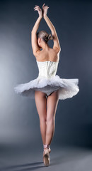 Graceful slim ballerina dancing back to camera © Wisky