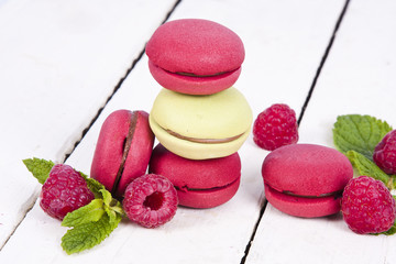 macaroons stacked on white wooden background, cupcakes