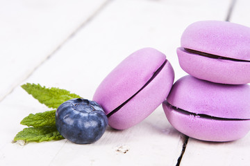 macaroons stacked on white wooden background, cupcakes