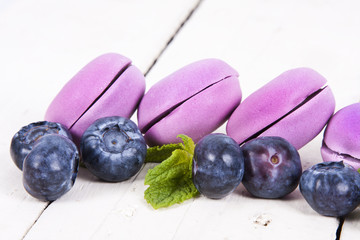 macaroons stacked on white wooden background, cupcakes