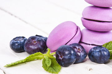 macaroons stacked on white wooden background, cupcakes