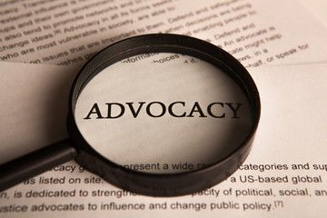 document with the title of advocacy under a magnifying glass