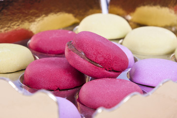 macaroons stacked on white wooden background, cupcakes