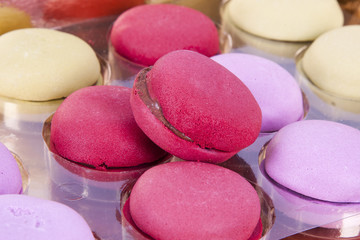 macaroons stacked on white wooden background, cupcakes