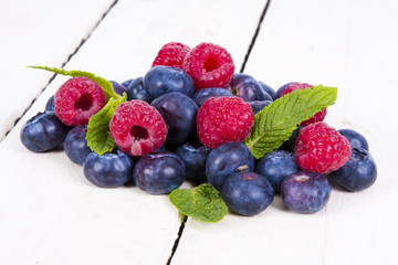 berries blueberries and raspberries stacked on wood