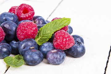 berries blueberries and raspberries stacked on wood