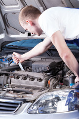 Mechanic fixing car engine