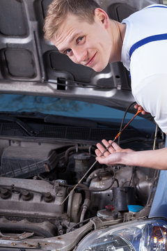Handyman checking engine oil