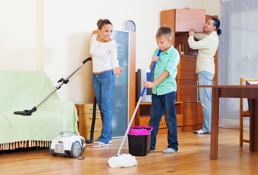 Family Of Three With Teenager Doing Housework