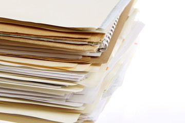 Stack of filing in manila folders on white 