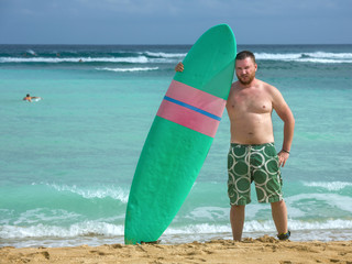 Surfer with surfboard in the ocean