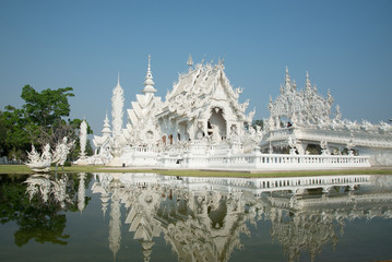 Grand white church and reflection in the water, Wat Rong Khun Ch