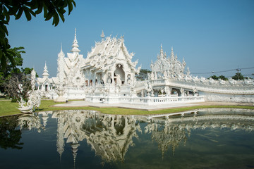 Grand white church and reflection in the water, Wat Rong Khun Ch