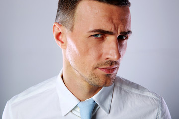 Portrait of a handsome businessman on gray background