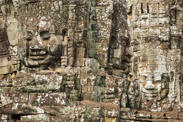 Stone faces on the towers of ancient Bayon Temple in Angkor Thom
