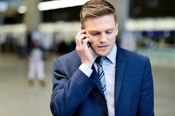 Businessman talking on phone outdoors