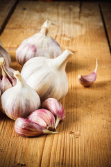 Raw garlic on wooden background