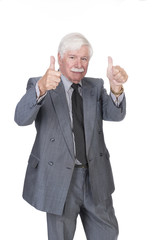 Old man in suit and gray hair with both hands showing thumbs up