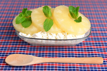 Bowl of tasty cottage cheese with pineapple, close up