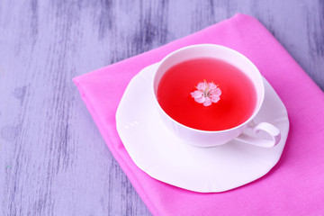 Fragrant tea in cup on wooden table close-up