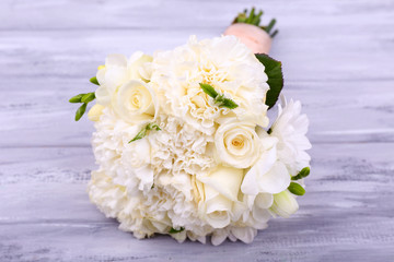 Beautiful wedding bouquet on wooden background