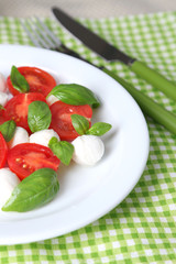 Caprese salad with mozarella cheese, tomatoes and basil