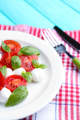 Caprese salad with mozarella cheese, tomatoes and basil