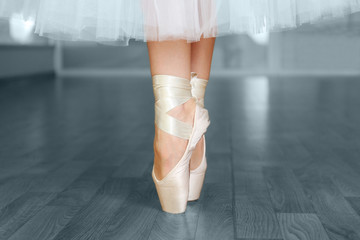 Ballerina legs in pointes in dancing hall © Africa Studio