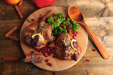 Roasted quails  on cutting board, on wooden table background