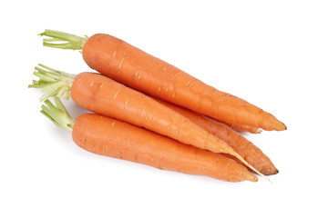 raw and fresh carrots in closeup over white