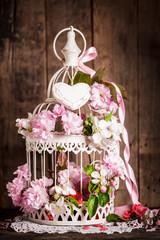 Bird cage with wooden heart