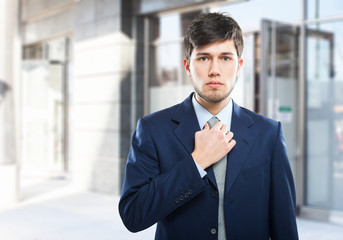 Businessman adjusting his necktie