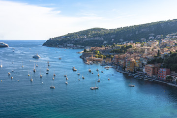 Aerial view of Villefranche-sur-Mer coast with yachts sailing in