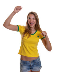 Cheering woman in a brazilian shirt