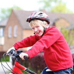 Fototapeta na wymiar Portrait of happy school boy on his bike