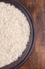 Plate of Rice on Dark Wood Background