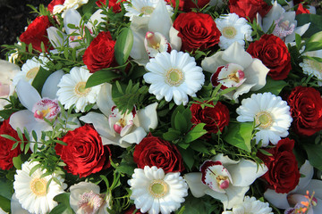 Cymbidium orchids, red roses and white gerberas