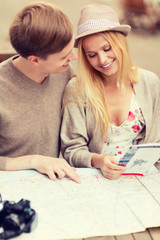 couple with map, camera and travellers guide