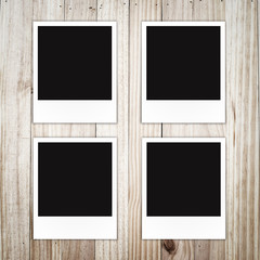 Polaroid photo frame on wood background