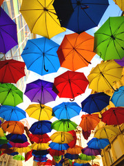 Fototapeta na wymiar A lot of multicolored umbrellas over the sky